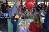 Fireman talking to girl with balloon